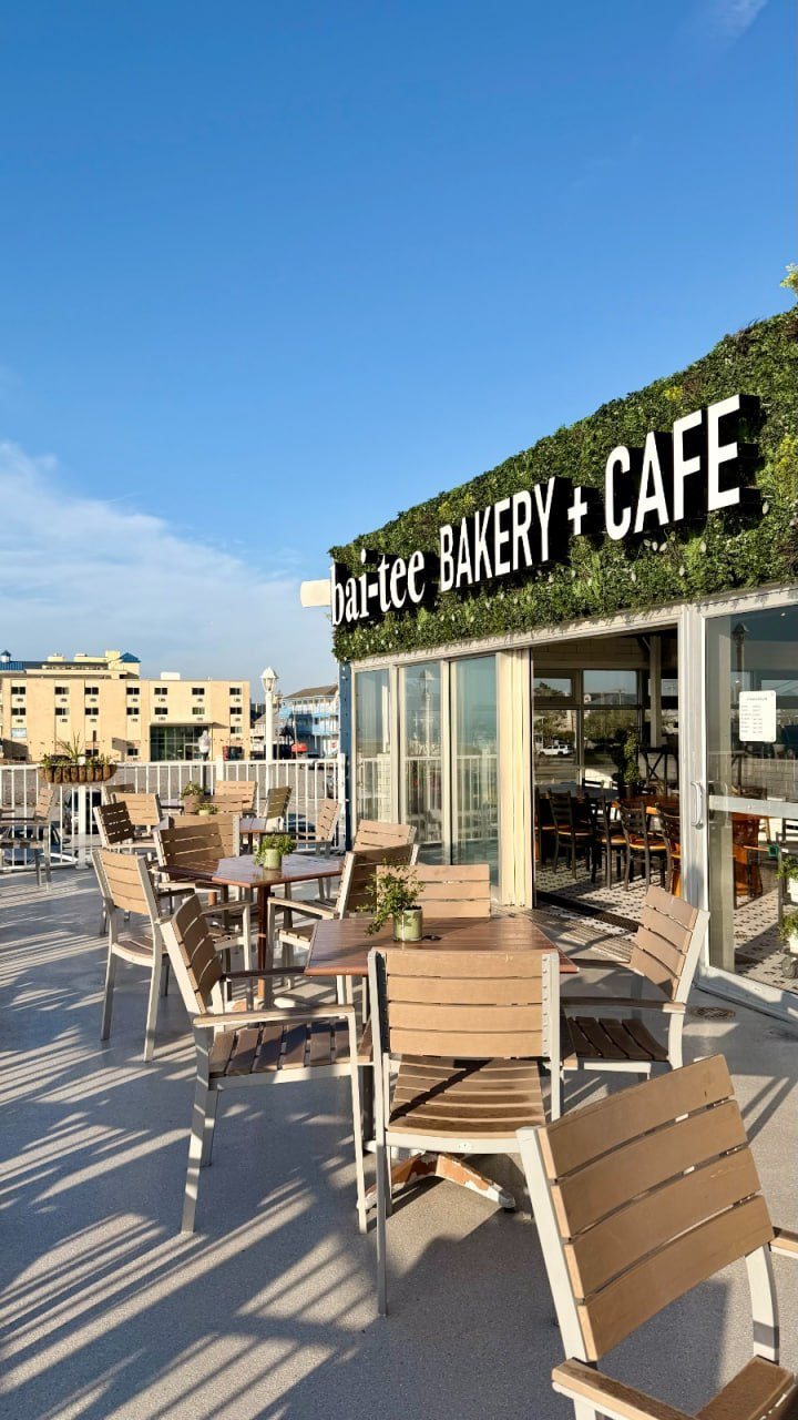 bai-tee Bakery + Café entrance on the Ocean City boardwalk under a blue sky